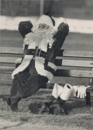 Santa relaxing on a park bench 1988