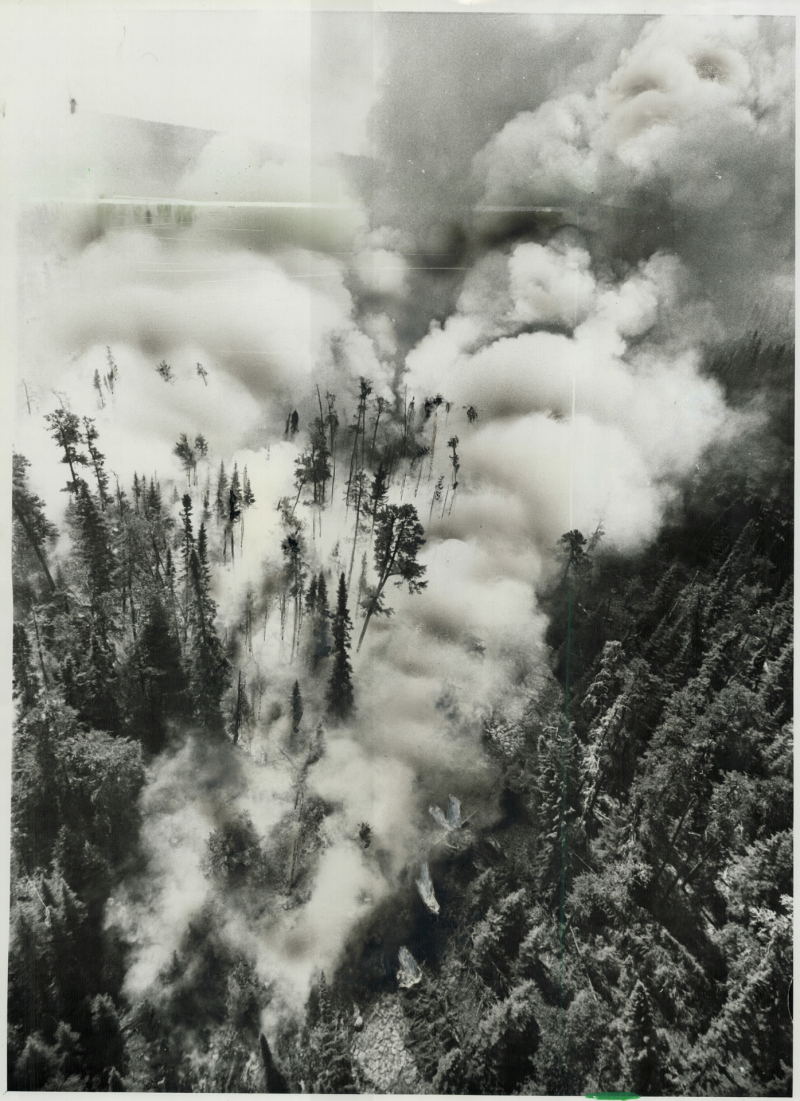 Four men on a roof looking out at ruins from a fire Four men on a roof looking out at ruins from a fire