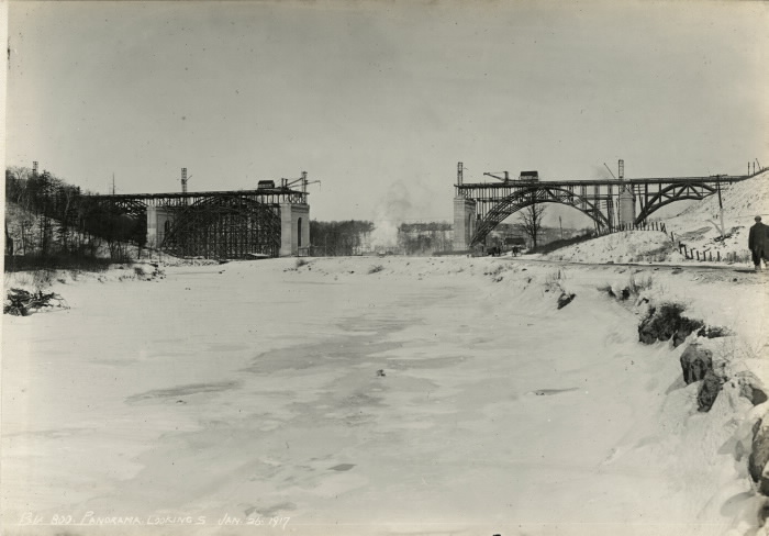 Bridge under construction with middle section missing  set in a snowy landscape