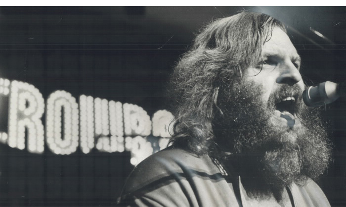 Bearded man signing in microphone Bearded man signing in microphone