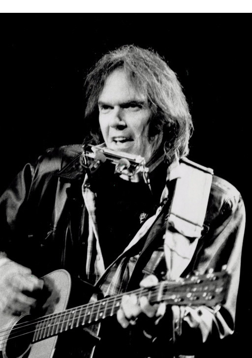 Man with acoustic guitar and harmonica performing Man with acoustic guitar and harmonica performing