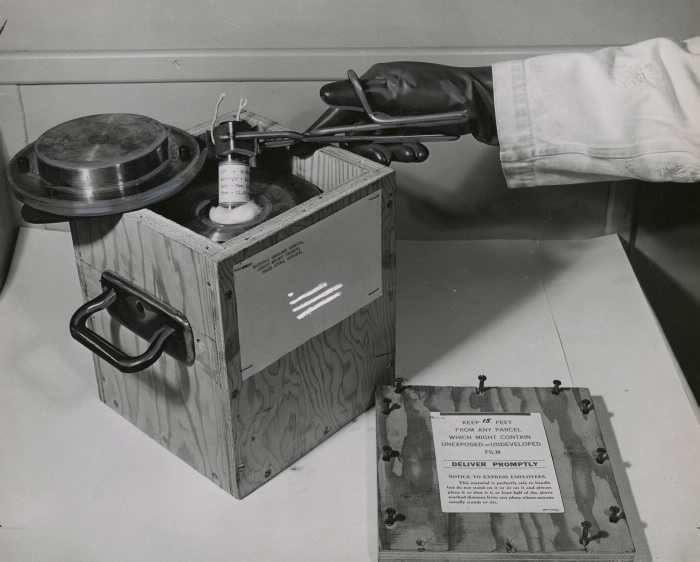 Pulling a small amount of radioactive material from a special transportation case
