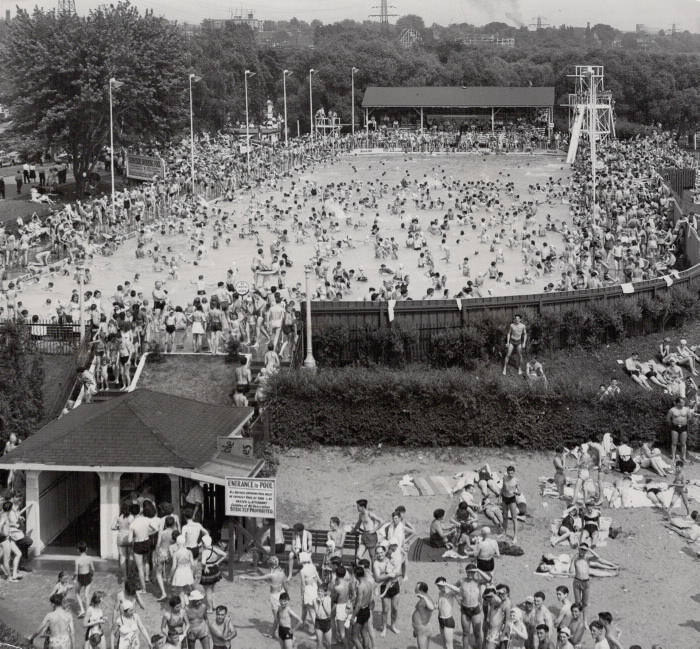 Huge crowd of swimmers in and around a large pool