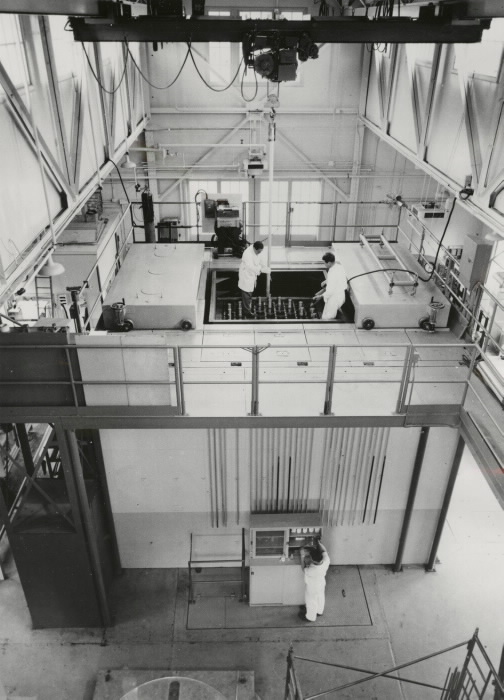 Overhead view of laboratory workers in a facility with large machines