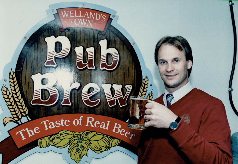 Moe Coutu, general manager of the Atlas Hotel in Welland, raises a glass in a toast to the emblem of his pub's made-in-the-house brew in 1986
