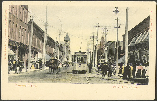 Postcard of busy street with street car