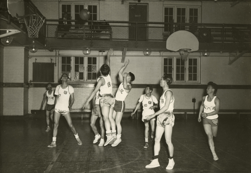 Men's basketball game in progress in a gym