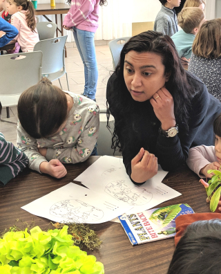 Broti teaching children indoors.