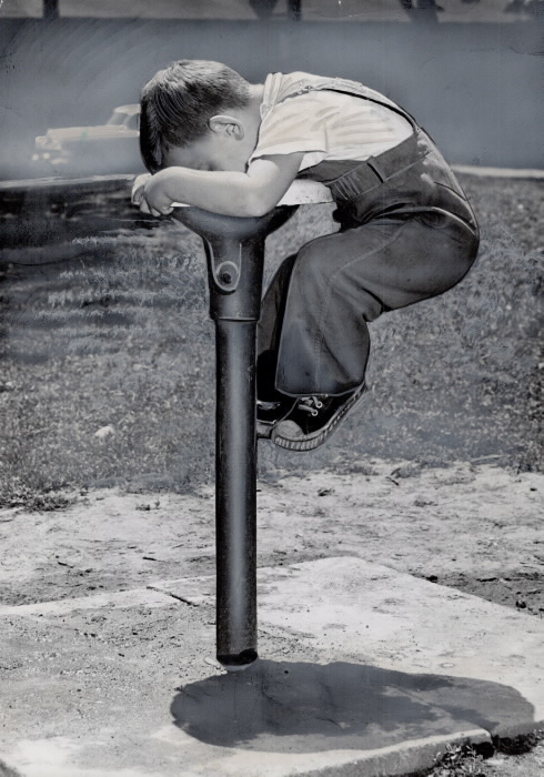 Boy Climbing on Fountain