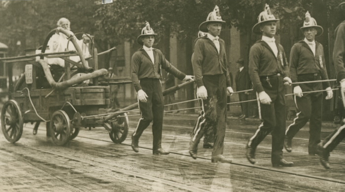 1923 photo of Toronto Labour Day Parade of firemen pulling Toronto's original fire wagon