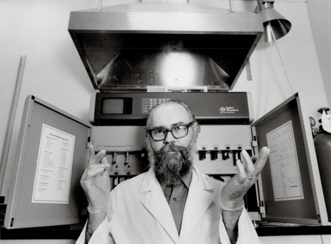 A Canadian genetic engineer before a DNA synthesizer back in 1985. An image still aligned with popular consciousness of laboratory research. Image courtesy of Digital Archive Ontario.