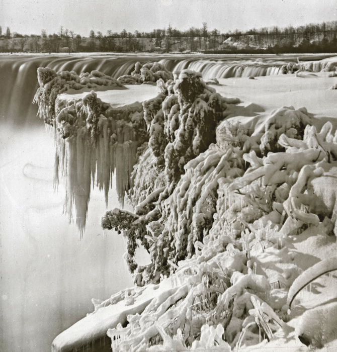 Frozen tree in front of water falls