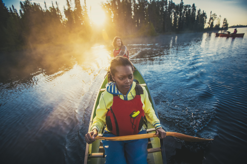 Two people paddling a canoe.
