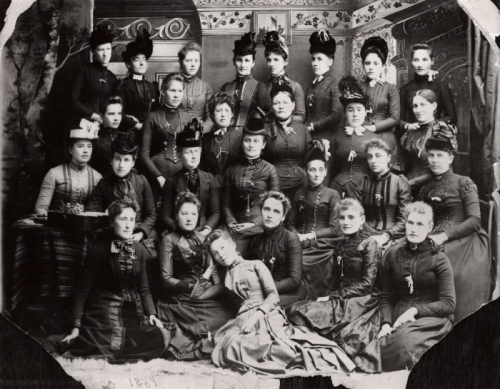 Black and white portrait of 26 women seated and standing