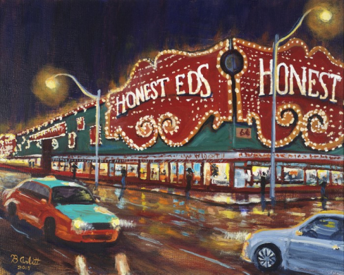 A car and taxi drive passed the brightly illuminated signage of Honest Ed's department store at night. The road appears wet and reflects the signage and street lights.
