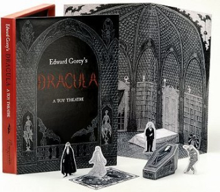 Paper cutouts of characters and set pieces feature Edward Gorey's distinctive pen-and-ink drawings.