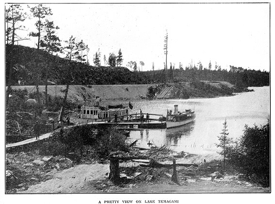 Lake with jetty and boats and subtitle A pretty view on Lake Temagami