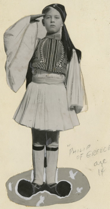 Cut out of young boy saluting in traditional outfit with pencil lettering reading Philip of Greece age 14 Cut out of young boy saluting in traditional outfit with pencil lettering reading Philip of Greece age 14