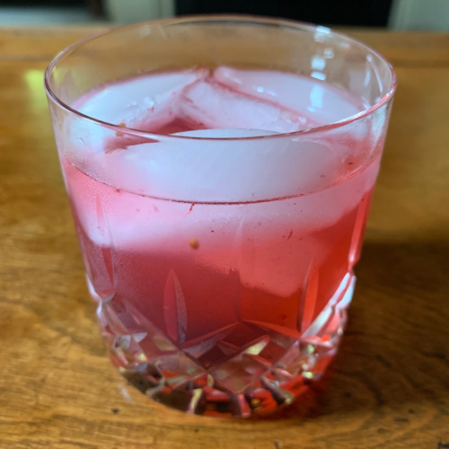 A new cocktail, The Librarian, Gin, lemonade and crushed mulberries in a crystal glass.