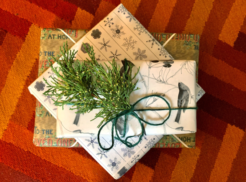Photograph of three gifts wrapped with paper from TPL's Special Collections