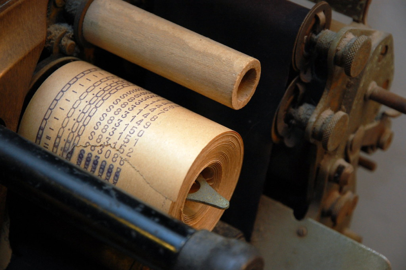 Old wood machine with receipts on sppols