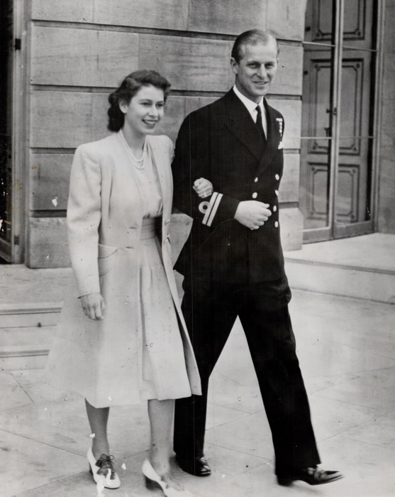 Princess Elizabeth walking hand in hand with man in uniform
