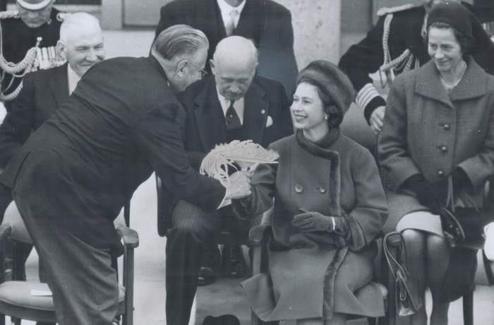 Man handing the Queen flowers