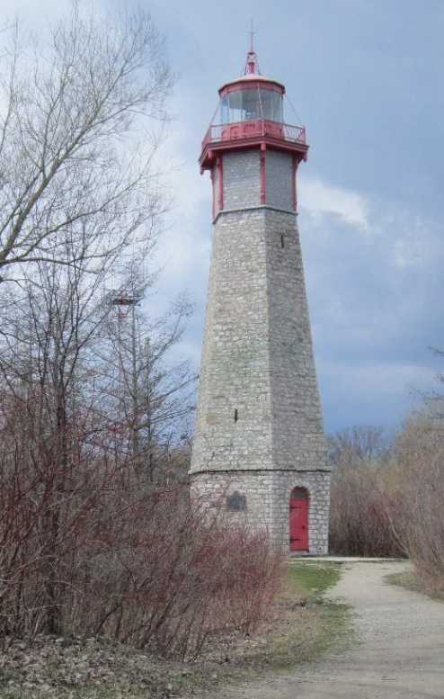White lighthouse with dirt path during daytime