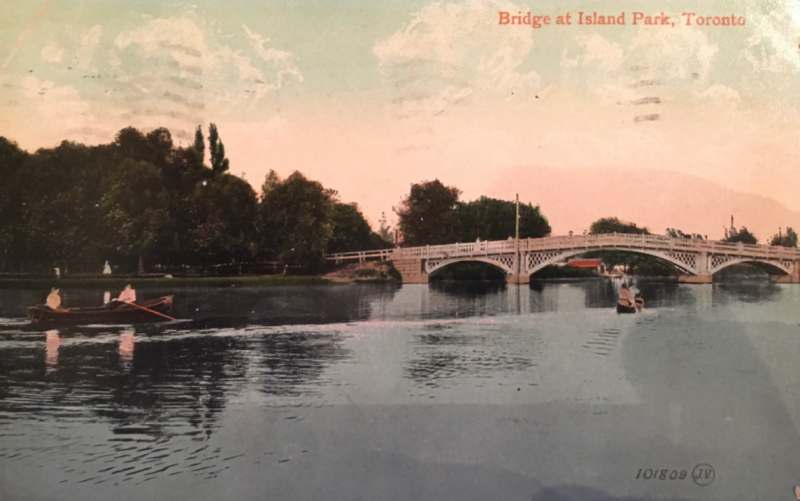Vintage postcard showing rowers and canoes approaching bridge and words Bridge at Island Park Toronto