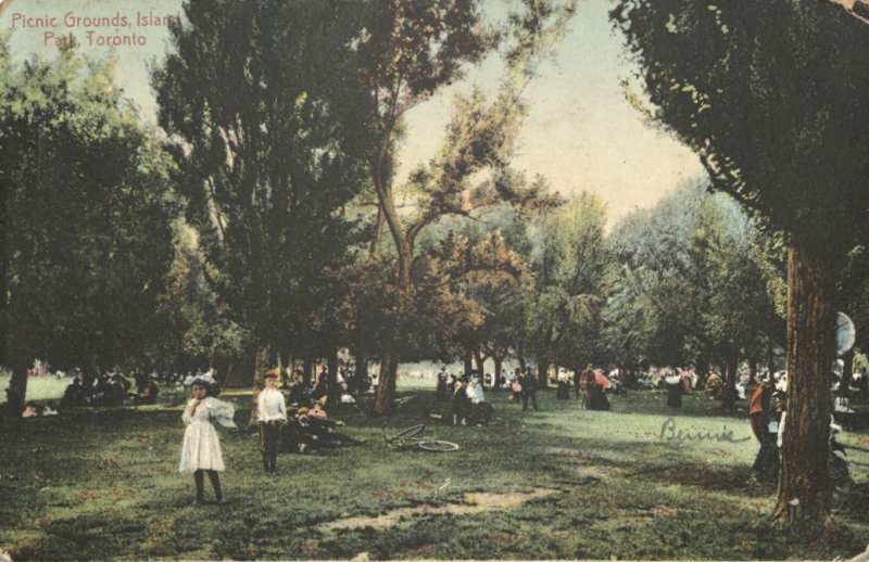 Postcard of children and others in park with words in corner of postcard reading Picnic Grounds Island Park Toronto