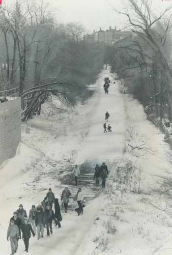 Kids walk along a trail in winter.
