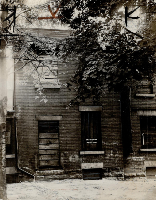 Boarded up brick house