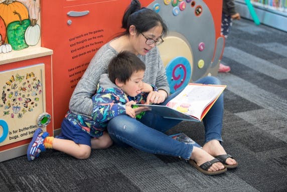 Mother and child reading a picture book.
