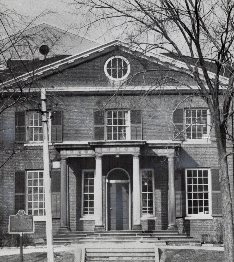 Front of old building with front door and columns