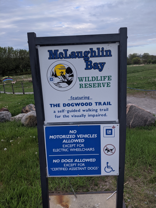 A welcome sign for McLaughlin Bay - Dogwood Trail, a self-guided walking trail for the visually impaired.
