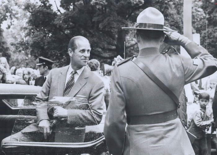 Prince Philip entering car with officer saluting him Prince Philip entering car with officer saluting him