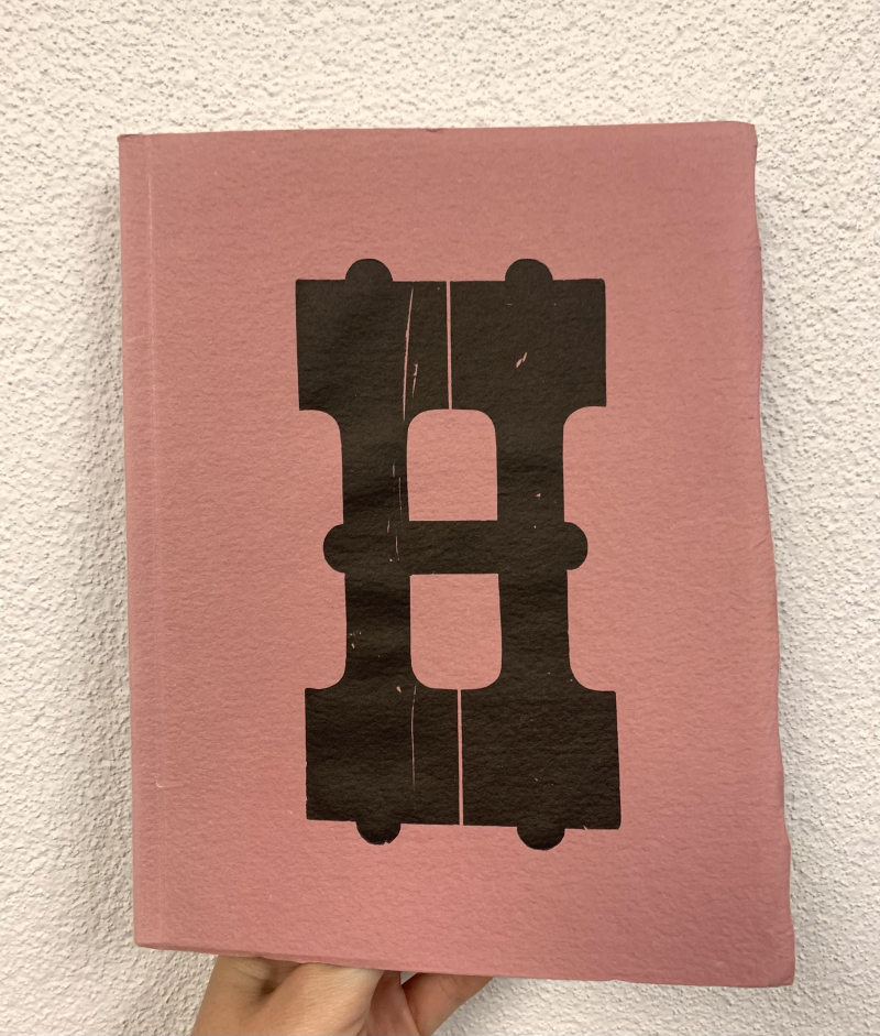 Large format wood letter "H" on a front cover