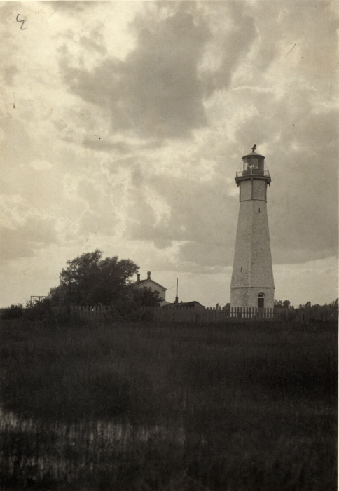 Vintage photo of lighthouse with dark clouds in background Vintage photo of lighthouse with dark clouds in background