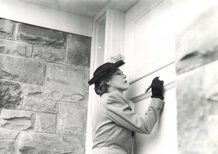 Mary Pickford signing door of house