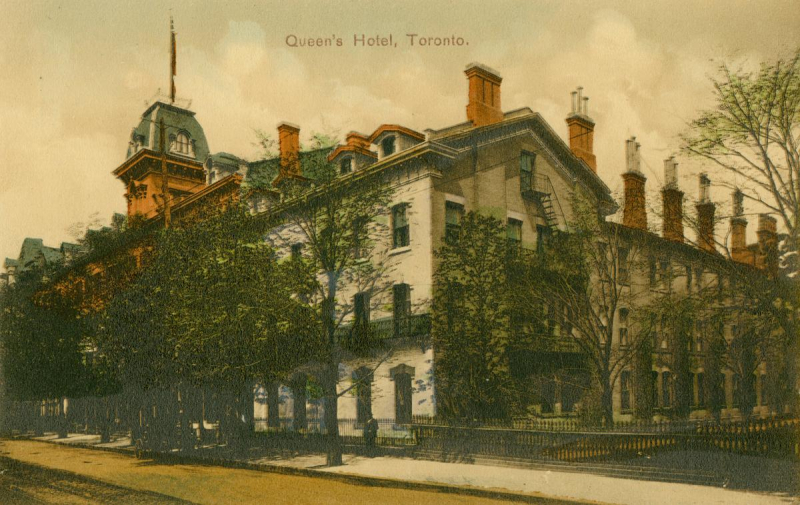 Corner building on tree lined street with words Queen's Hotel Toronto