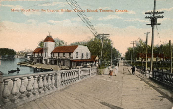 Vintage postcard of bridge and dock and words reading Main Street from the Lagoon Bridge Centre Island Toronto Canada