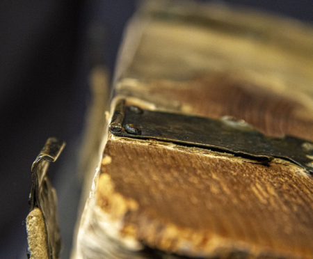 Outside of binding for vintage book with detached metal clasp