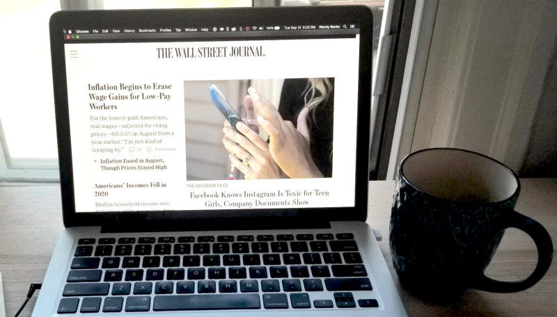 The Wall Street Journal website's home page, open on a laptop, showing articles about low-income workers and the negative impact of social media The Wall Street Journal website's home page, open on a laptop, showing articles about low-income workers and the negative impact of social media