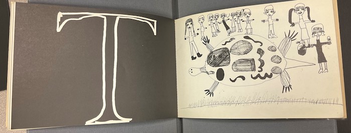 Two pages of Alphabet Book (1968) with the letter T and an illustration of a turtle surrounded by people