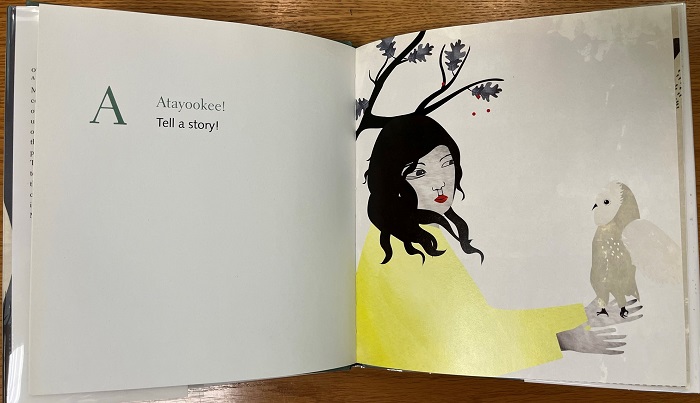 Page from Lii Yiiboo Nayaapiwak lii Swer with text "A Atayookee! Tell a Story!" and accompanying illustration