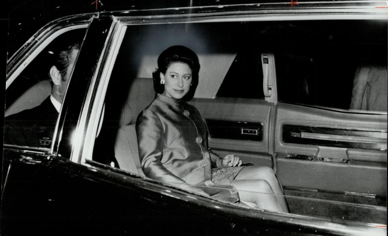 Woman in back of car in formal wear at night