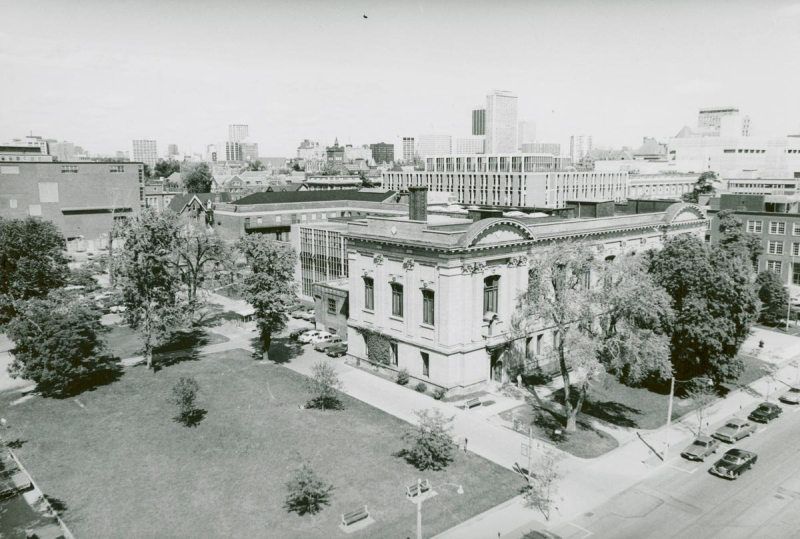 Aerial view of large building beside empty park