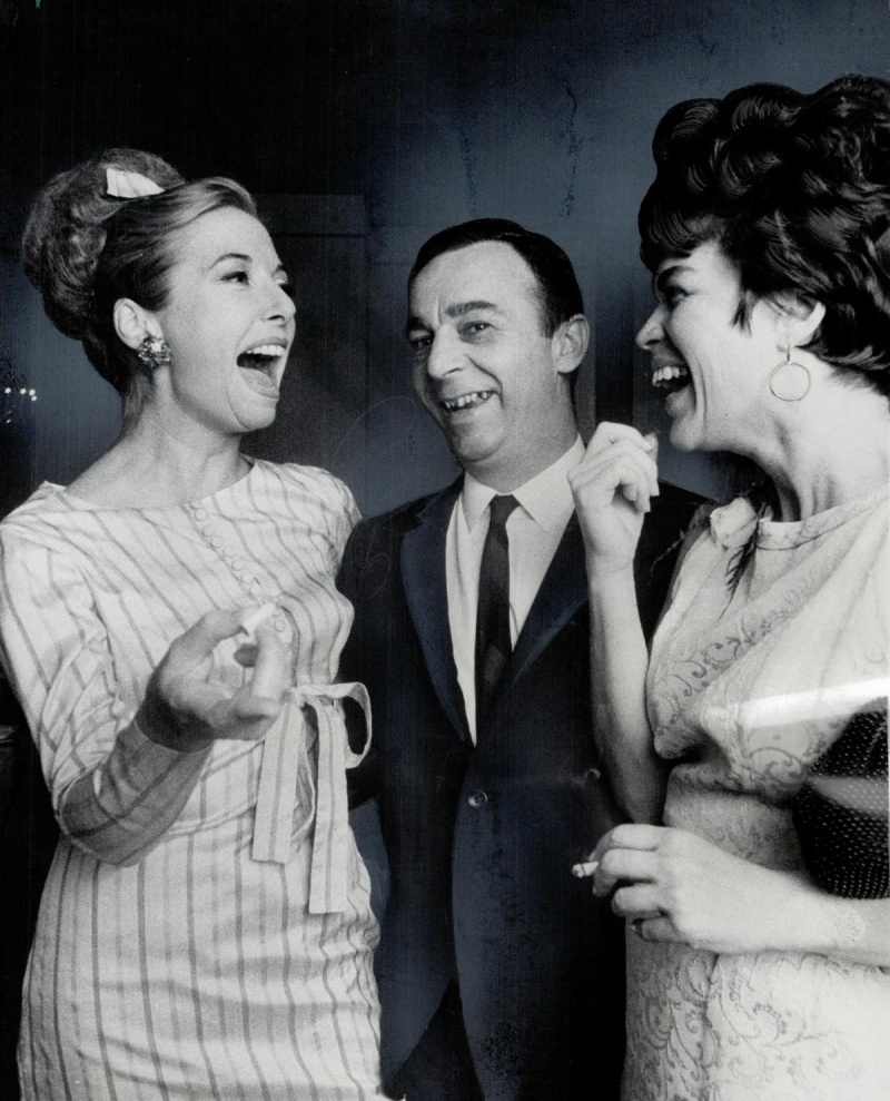 Two similing women and man in formal wear