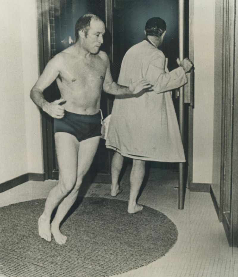 Pierre Trudeau in bathing suite walking inside