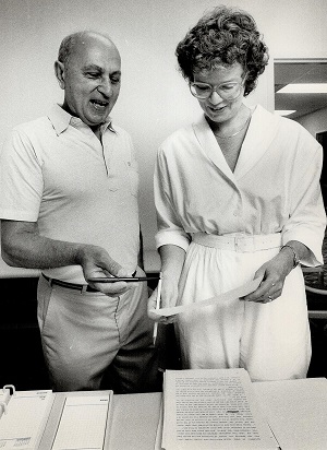 Author Heather Robertson goes over a manuscript with aspiring writer at North York Central Library